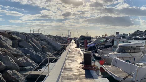 Caminando-Por-El-Puerto-De-Puerto-Banús-Con-Yates-Y-Barcos-De-Lujo-En-La-Soleada-Marbella,-Famoso-Destino-De-Vacaciones-En-España,-Tiro-4k