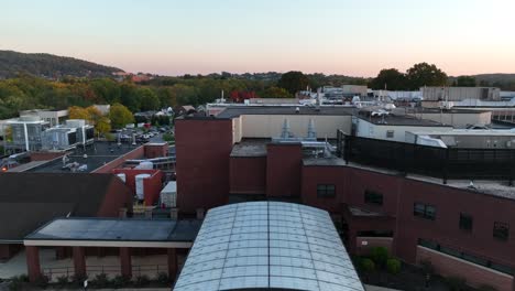 Rising-aerial-shot-features-emergency-room-and-hospital-at-sunrise