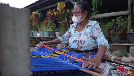 Una-Madre-Está-Tejiendo-Motivos-Florales-Indonesios