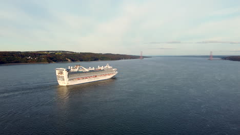 Drone---View-of-the-Caribbean-Princess-cruise-ship-over-the-Saint-Lawrence-River,-from-the-south-shore-of-Quebec-city,-cruising-north-to-La-Baie,-Quebec,-Canada