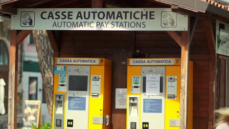 Woman-taking-a-ticket-from-an-automatic-paying-station-for-parking