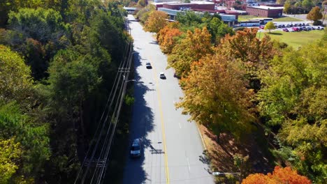 Old-Salem-Pedestrian-Bridge-with-Fall-leaves,-Winston--Salem,-NC