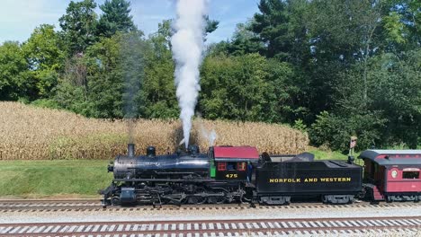 Ronks,-Pennsylvania,-August-26,-2018---Drone-View-of-an-Antique-Steam-Passenger-Train-Traveling-Thru-Farmlands-Blowing-Smoke-and-Steam