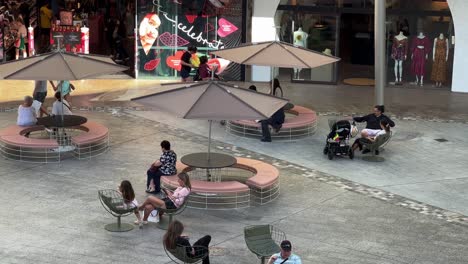 Cautious-shoppers-strolling-and-window-shopping-at-pacific-fairs-shopping-centre-in-Gold-Coast,-Broadbeach,-quiet-mall-due-to-inflation-hike,-people-with-less-purchasing-power