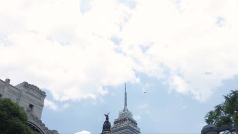 Tilt-down-shot-of-Entrance-tu-the-fine-arts-palace-subway-station-with-the-palace-dome-and-a-skyscraper-in-the-back