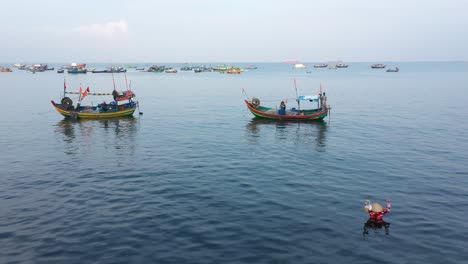 Small-Vietnamese-fishing-boats-returning-to-shore-after-a-night-at-sea