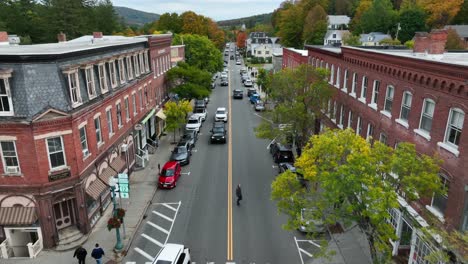 Aerial-tracking-shot-of-quaint-main-street-shopping-on-a-crisp-fall-morning