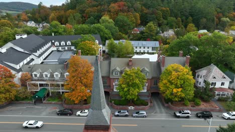 Slow-motion-truck-shot-of-white-car-driving-down-quaint-American-small-town-street