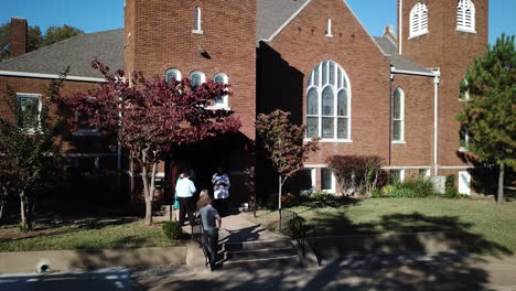 drone-shot-of-congregation-queues-in-front-of-the-church,-Los-Angeles