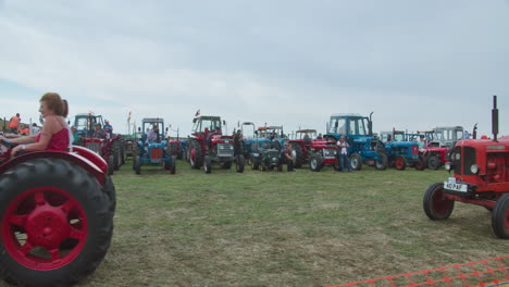 Adult-People-Riding-David-Brown-Cropmaster-And-Nuffield-1060-Vintage-Tractors-At-The-Great-Trethew-Rally-In-Liskeard,-UK