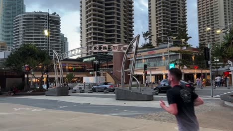 Popular-seaside-destination,-tourists-and-locals-visiting-surfers-paradise-with-cars-driving-on-the-esplanade,-severe-weather-approaching-at-Gold-Coast,-Queensland,-Australia