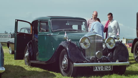 Men-Standing-By-A-Green-Bentley-3