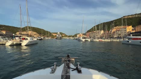 Fpv-Point-of-view-from-bow-of-boat-sailing-in-Bonifacio-port-on-Corsica-island-in-France-with-big-luxury-yachts-moored