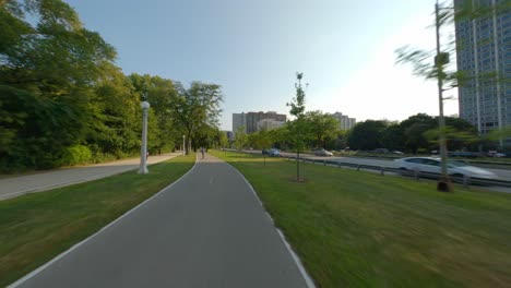 Lapso-De-Tiempo-De-Un-Paseo-En-Bicicleta-Hacia-El-Sur-En-El-Sendero-Para-Bicicletas-Frente-Al-Lago-De-Chicago,-Corriendo-Y-Caminando-Por-Un-Sendero-A-Orillas-Del-Lago-Michigan