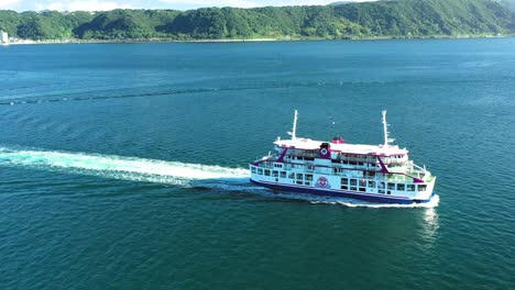 Aerial-view-of-cruising-Sakurajima-Ferry-in-Kinko-Bay,-Kagoshima,-Japan