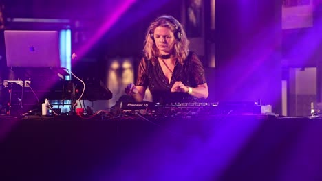 Female-Disc-Jockey-Performing-With-Fancy-Equipment-On-The-Stage-During-Concert