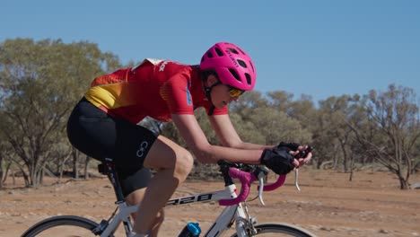 Tracking-shot-of-a-female-cyclist,-close-up-to-wide