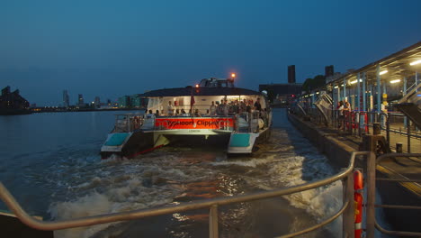 Night-Cruise-Via-Typhoon-Clipper-Passenger-Boats-At-Greenwich-Pier-On-The-South-Bank-Of-River-Thames-In-London,-UK