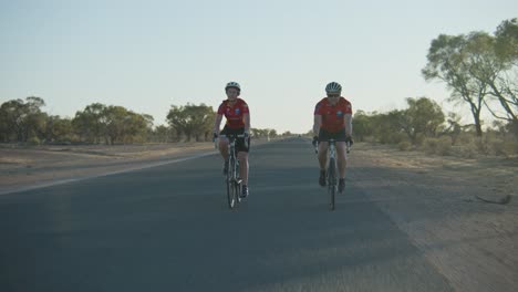 Head-on-tracking-shot-of-a-pair-of-cyclists-getting-close