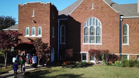 Rising-aerial-shot-of-worshipers-coming-out-of-a-church