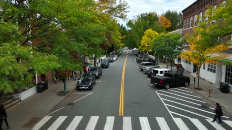 Low-aerial-drone-videography-of-street-parking-and-local-businesses-in-a-small-American-town