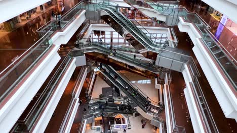 Tilting-shot-using-an-iPhone-13-Pro-Max-smartphone-of-Chinese-citizens-and-shoppers-enjoying-their-evening-at-a-retail-shopping-mall-in-Hong-Kong