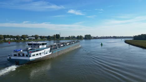 Aerial-Dolly-Right-Across-Stern-Of-Comus-2-Inland-Tanker-Along-Oude-Maas