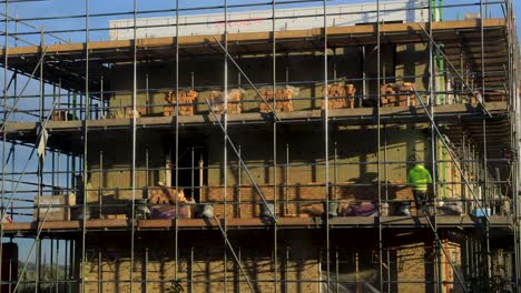 Time-lapse-of-brick-laying-construction-worker-building-the-exterior-facade-of-new-home-in-PUUR21-urban-development-real-estate-project