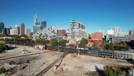 Drone-Footage-of-Passenger-Commuter-Train-Passing-Through-City-Center