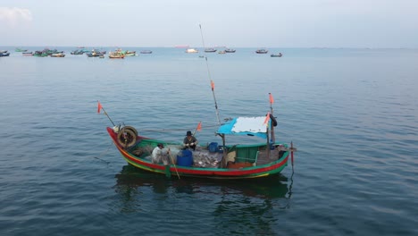 Ein-Kleines-Vietnamesisches-Fischerboot,-Das-Nach-Einer-Nacht-Auf-See-An-Land-Zurückkehrt