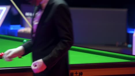 Neil-Robertson,-an-Australian-professional-snooker-player,-plays-a-shot-as-he-hits-a-ball-during-a-match-at-the-Hong-Kong-Masters-snooker-tournament-event