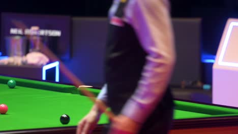 Neil-Robertson,-an-Australian-professional-snooker-player,-plays-a-shot-as-he-strikes-a-ball-during-a-match-at-the-Hong-Kong-Masters-snooker-tournament-event