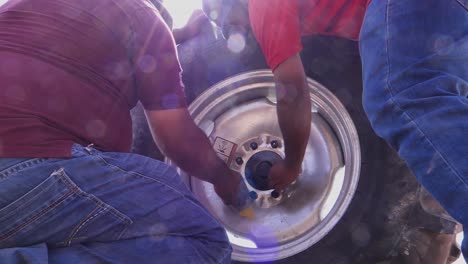 Low-Angle-View-Of-People-Fixing-Large-Tyre-Of-Center-Pivot-Irrigation-System