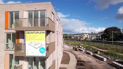 Aerial-pan-around-construction-site-information-banner-of-Ubuntuplein-revealing-the-whole-of-urban-development-real-estate-investment-project-in-Noorderhaven-neighbourhood