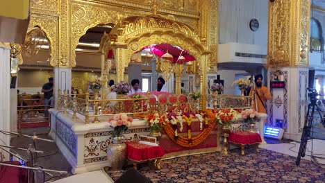 people-praying-at-gurudwara-from-back-from-flat-angle-video-is-taken-at-gurudwara-bangla-sahib-delhi-india-on-May-22-2022