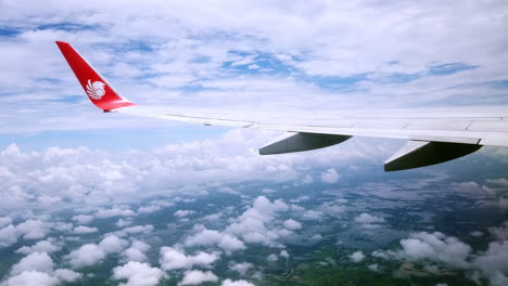 View-the-atmosphere-window-wing-of-a-Thai-Lion-Air-airplane-flight-in-sky-for-travel-transportation-on-holiday-at-Thailand