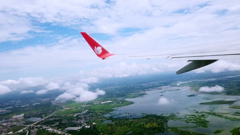 View-the-atmosphere-window-wing-of-a-Thai-Lion-Air-airplane-flight-in-sky-for-travel-transportation-on-holiday-at-Thailand