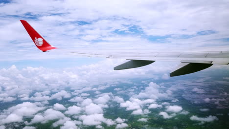 View-the-atmosphere-window-wing-of-a-Thai-Lion-Air-airplane-flight-in-sky-for-travel-transportation-on-holiday-at-Thailand