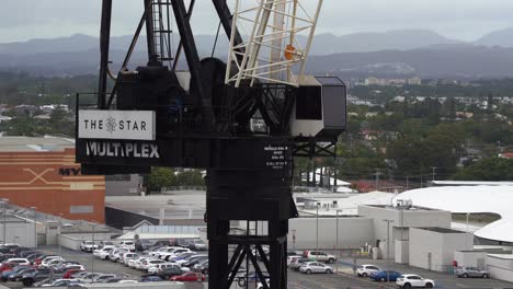 Multiplex-contractor-crane-working-on-Star-Residences-Gold-Coast-building-opposite-Pacific-fair-shopping-center,-construction-site,-working-in-progress,-Broadbeach-Island,-Queensland,-Australia