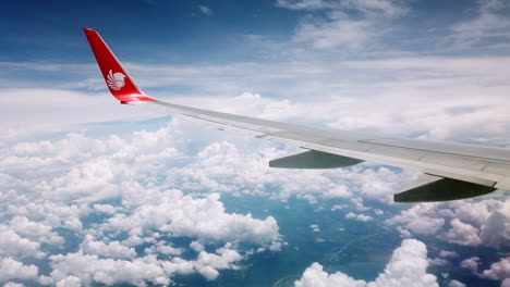 View-the-atmosphere-window-wing-of-a-Thai-Lion-Air-airplane-flight-in-sky-for-travel-transportation-on-holiday-at-Thailand