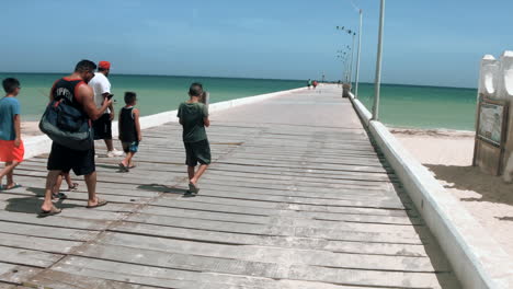 TOURISTS-WALKING-THROUGH-DOCK-AT-PUERTO-PROGRESO-LIFE-IN-MERIDA-YUCATAN-MEXICO