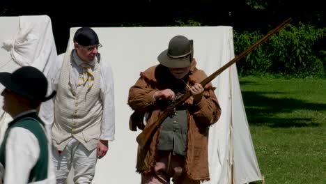 Settler-reenactor-checks-rifle