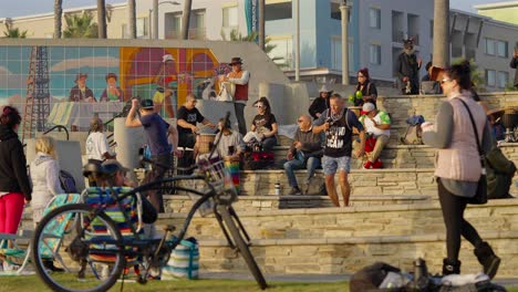 Hippies-dancing-at-a-drum-circle-in-Huntington-Beach,-CA