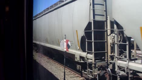 View-from-the-window-in-a-moving-train-passing-train-carriages