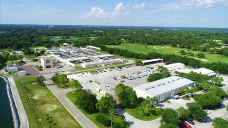 aerial-shot-rotating-around-a-waterfront-water-treatment-plant