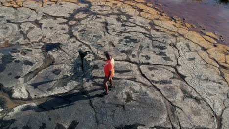 Aerial-footage-of-a-tour-guide-holding-natural-tar-from-the-mother-of-the-lake