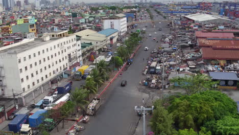 Toma-Aérea-De-Una-Carretera-Transitada-En-Un-área-De-Ocupantes-Ilegales-En-Manila-4k