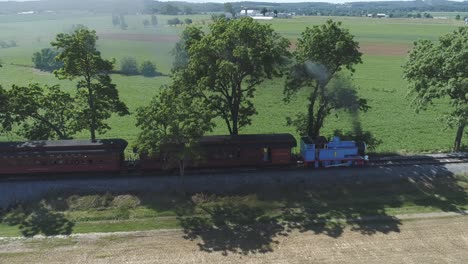 Aerial-View-of-a-Thomas-the-Tank-Engine-with-Passenger-Cars-Puffing-along-Amish-Countryside