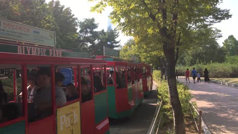 Tram-and-four-wheeled-bicycles-at-Olympic-Park,-Oryun-dong,-Songpa-gu,-Seoul,-South-Korea