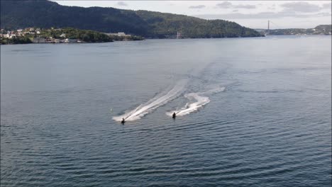 2-Jetskis-powering-into-Bergen,-Norway